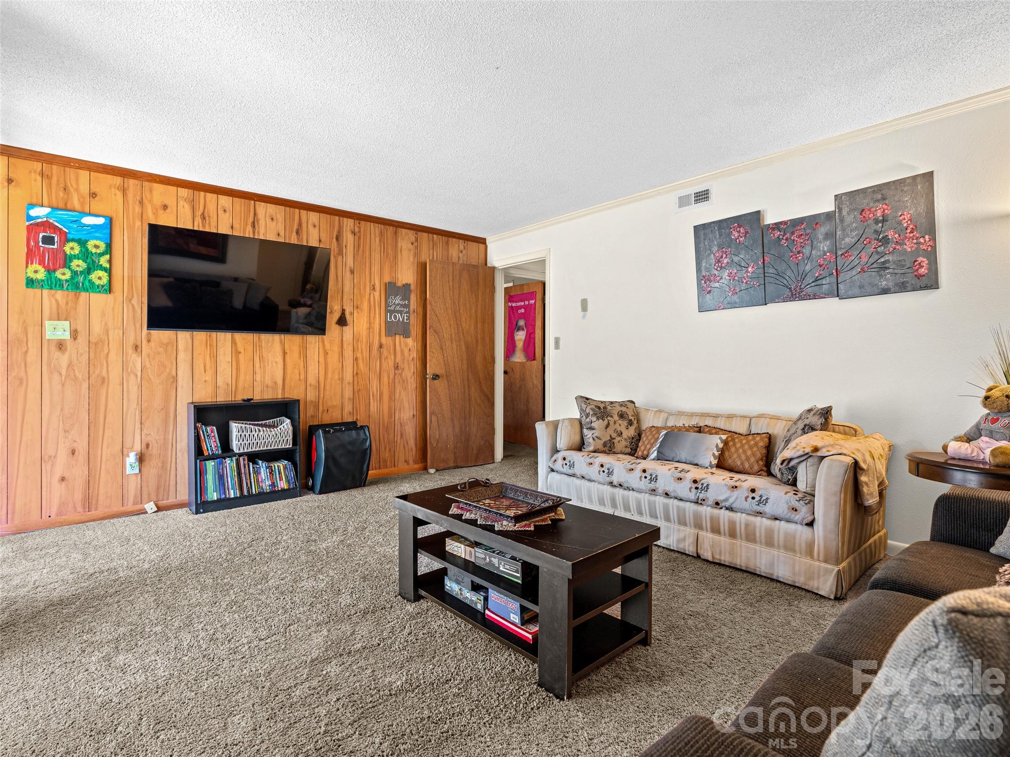 174 Pleasant Ridge Drive Maggie Valley, NC 28751 - Photo 28 of 45 a living room with fireplace furniture and a flat screen tv
