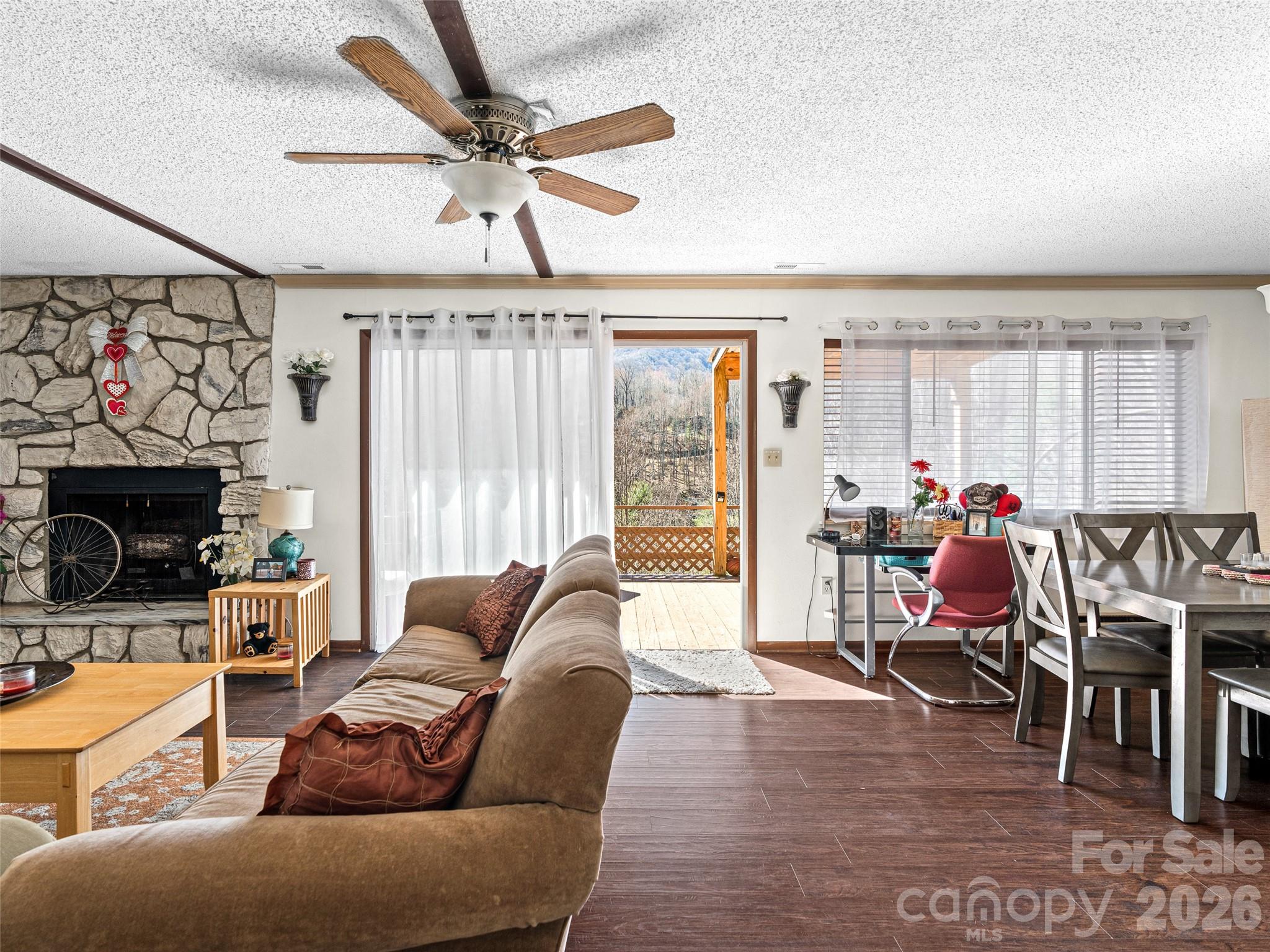 174 Pleasant Ridge Drive Maggie Valley, NC 28751 - Photo 3 of 45 a living room with furniture a fireplace and a chandelier