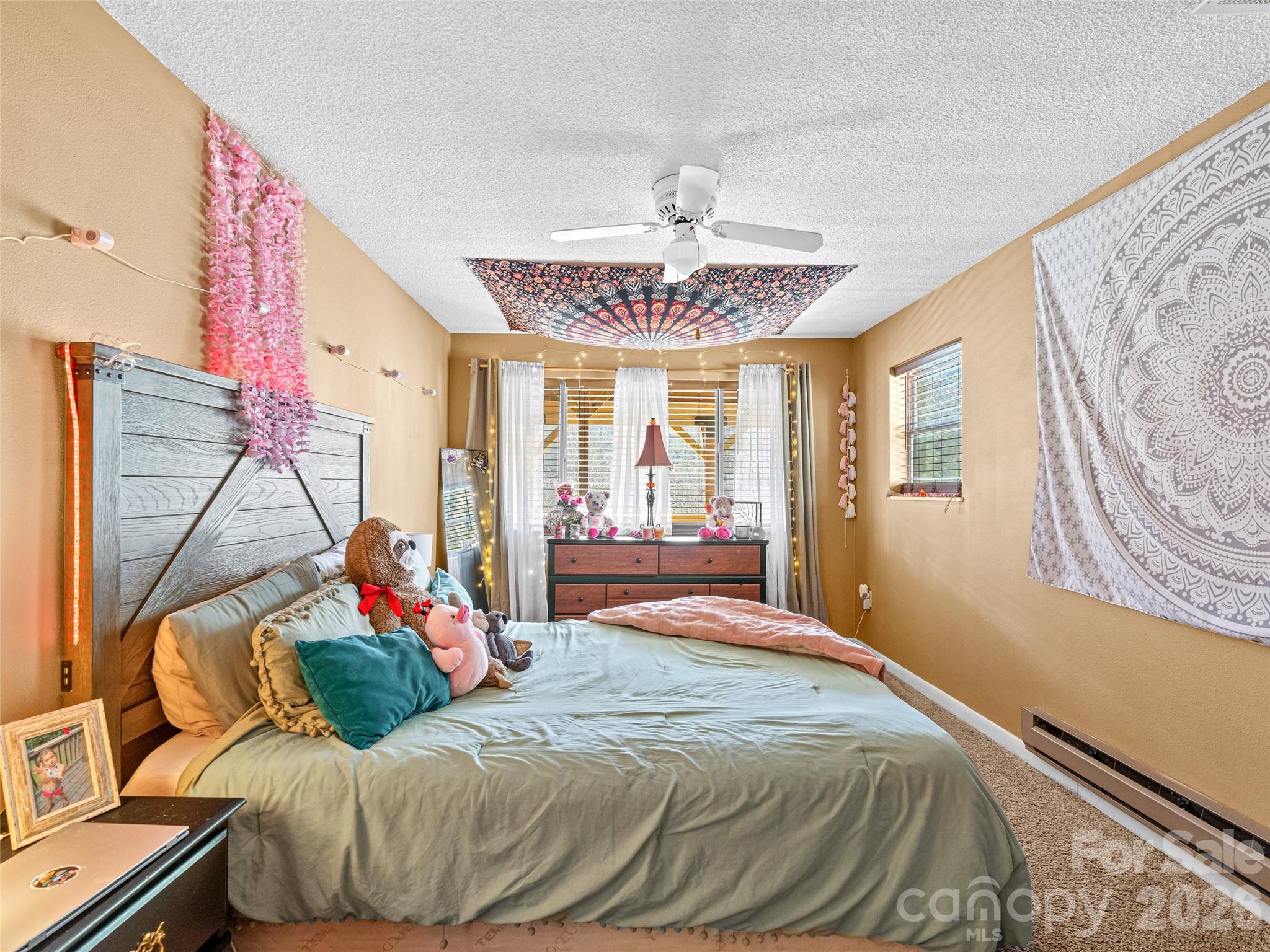 174 Pleasant Ridge Drive Maggie Valley, NC 28751 - Photo 37 of 45 a bedroom with a bed and a chandelier