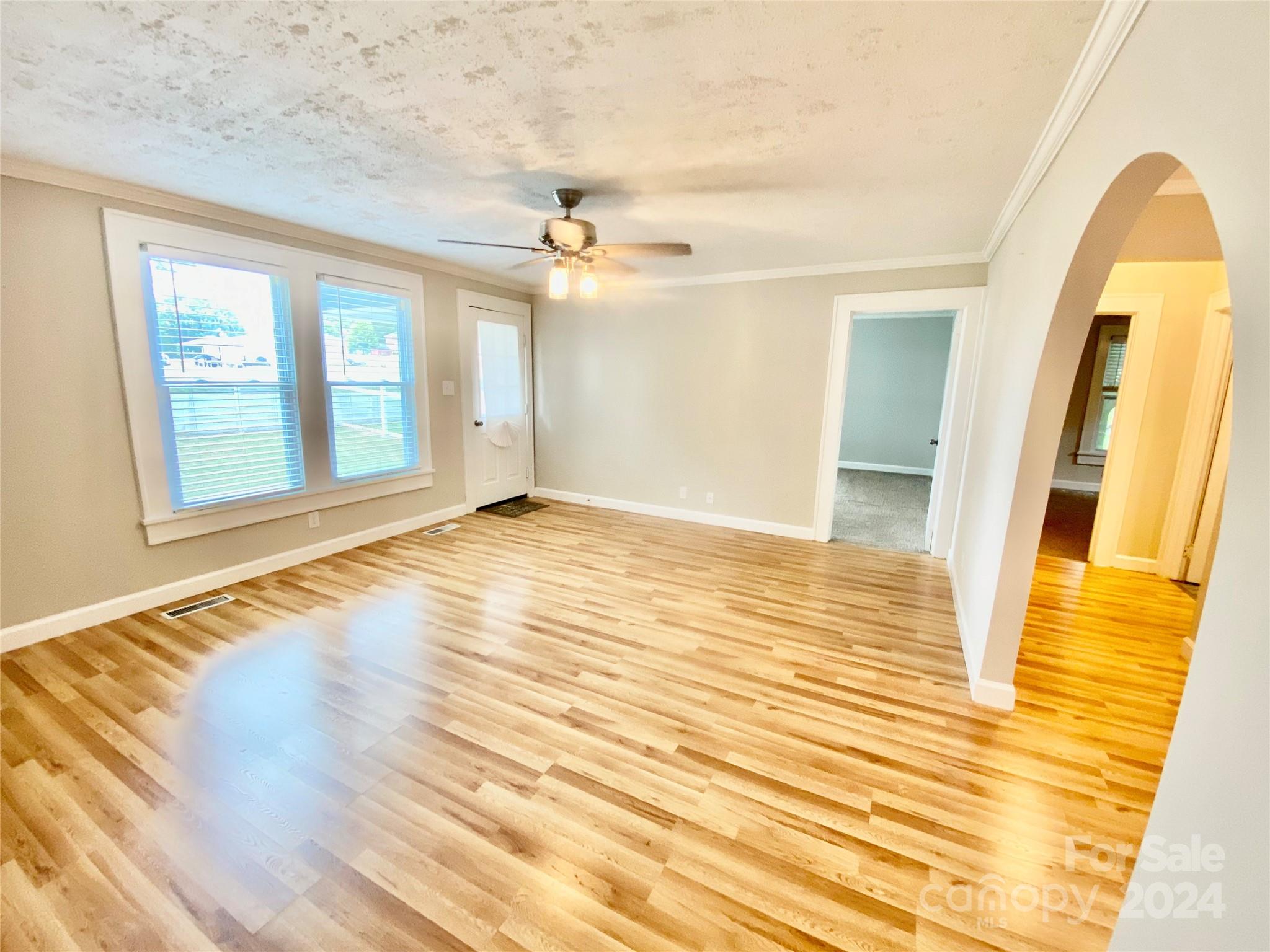 4250 Potneck Road Woodleaf, NC 27054 - Photo 19 of 36 a view of empty room with wooden floor and fan