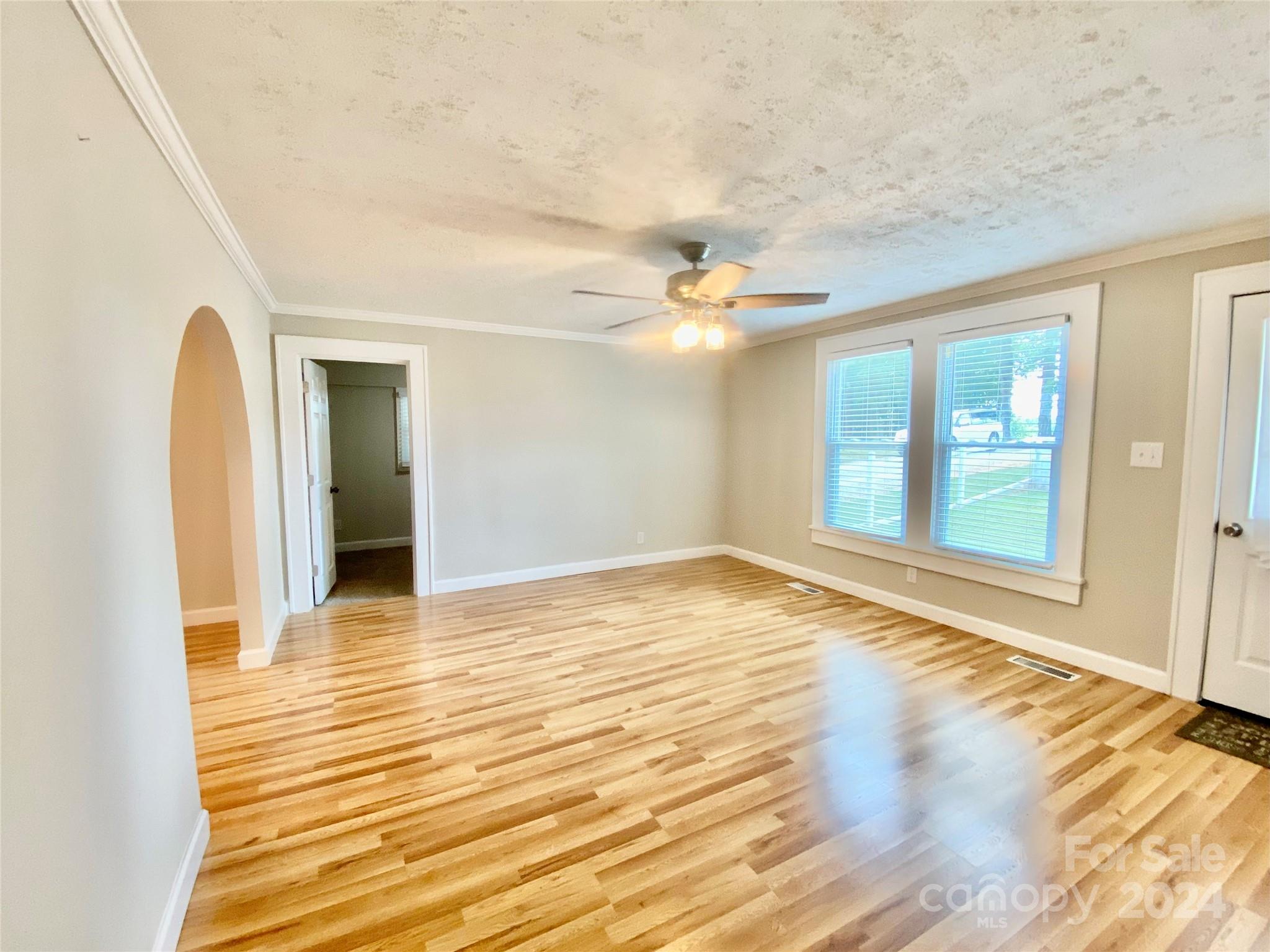 4250 Potneck Road Woodleaf, NC 27054 - Photo 20 of 36 a view of an empty room with wooden floor and a window