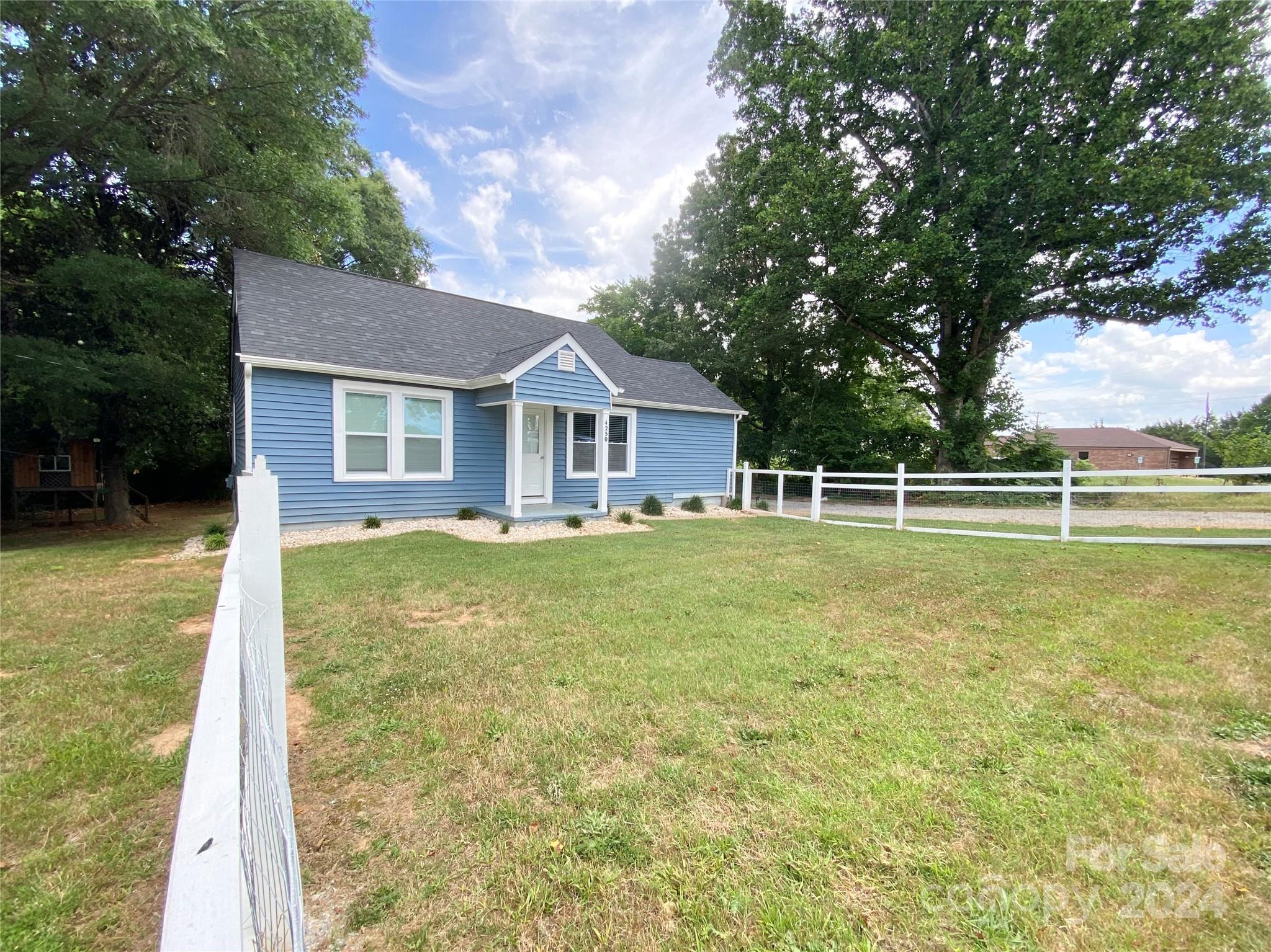 4250 Potneck Road Woodleaf, NC 27054 - Photo 2 of 36 a front view of a house with a yard