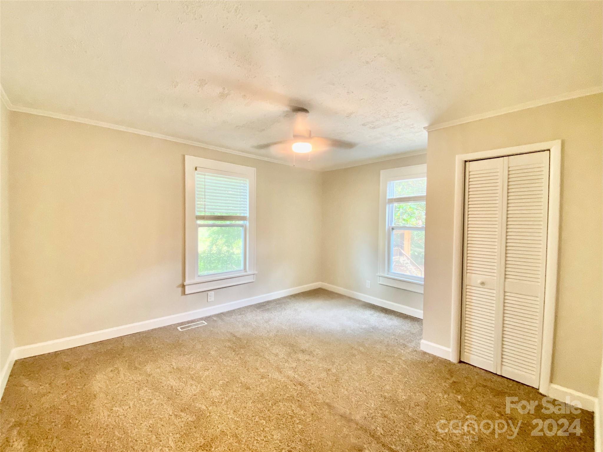 4250 Potneck Road Woodleaf, NC 27054 - Photo 29 of 36 an empty room with windows and closet
