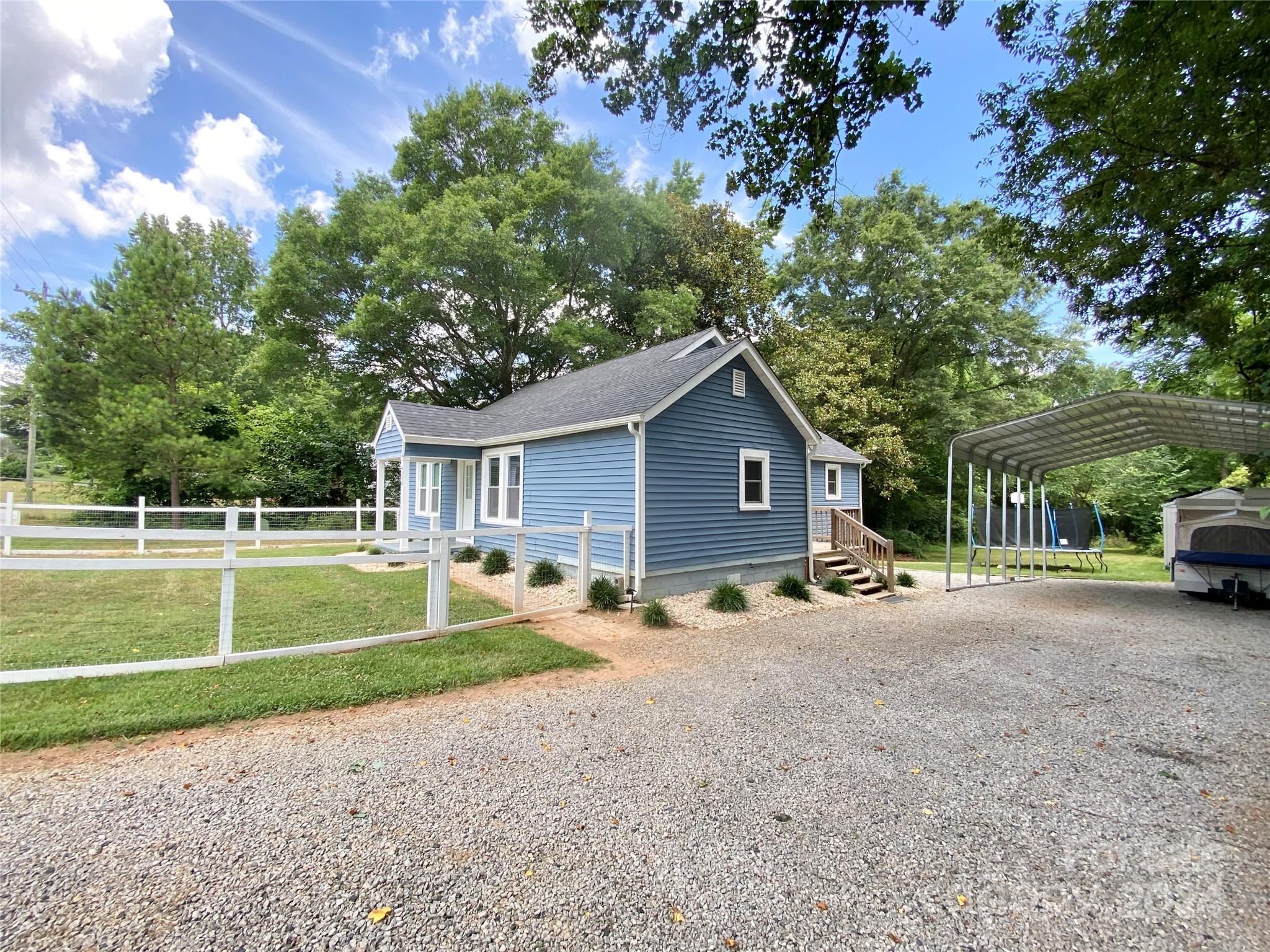 4250 Potneck Road Woodleaf, NC 27054 - Photo 5 of 36 a view of a house with a patio and a yard