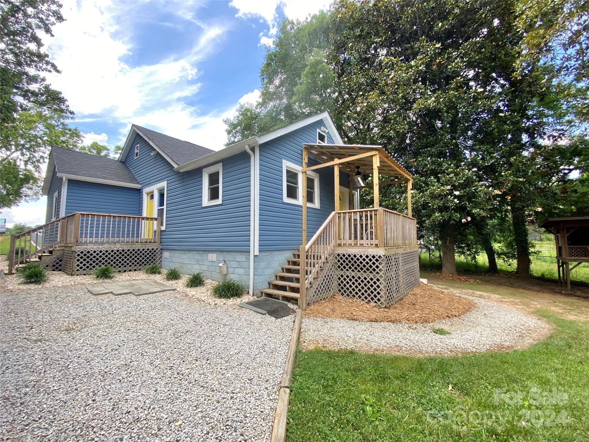 4250 Potneck Road Woodleaf, NC 27054 - Photo 8 of 36 a front view of a house with a garden