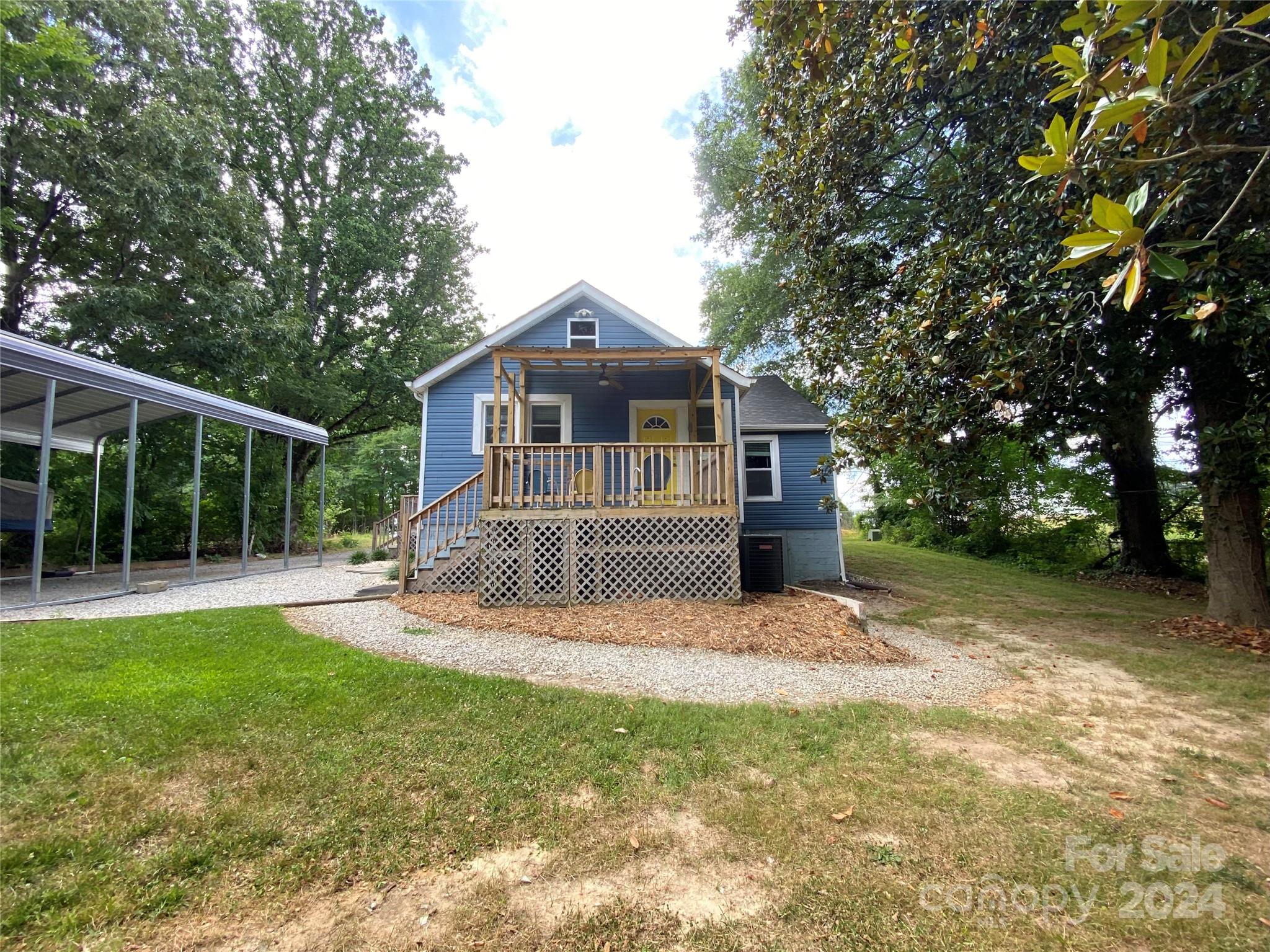 4250 Potneck Road Woodleaf, NC 27054 - Photo 9 of 36 a front view of a house with a yard and trees