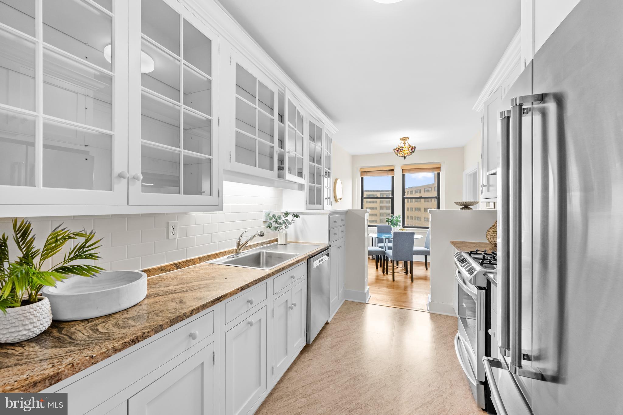 4701 Connecticut Avenue Northwest, Unit 501 Washington, DC 20008 - Photo 12 of 28 a kitchen with granite countertop lots of counter top space and windows