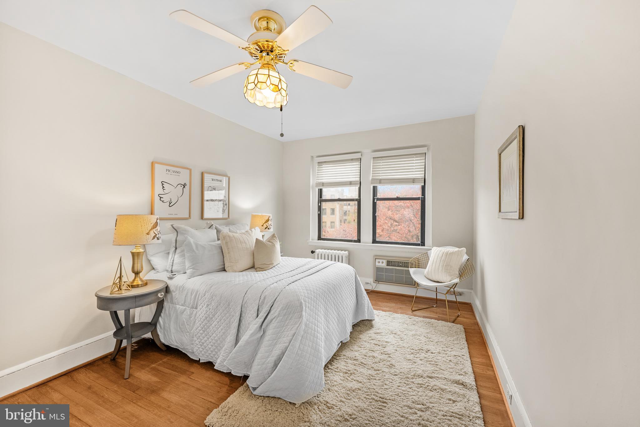 4701 Connecticut Avenue Northwest, Unit 501 Washington, DC 20008 - Photo 19 of 28 a bedroom with a bed and a chandelier