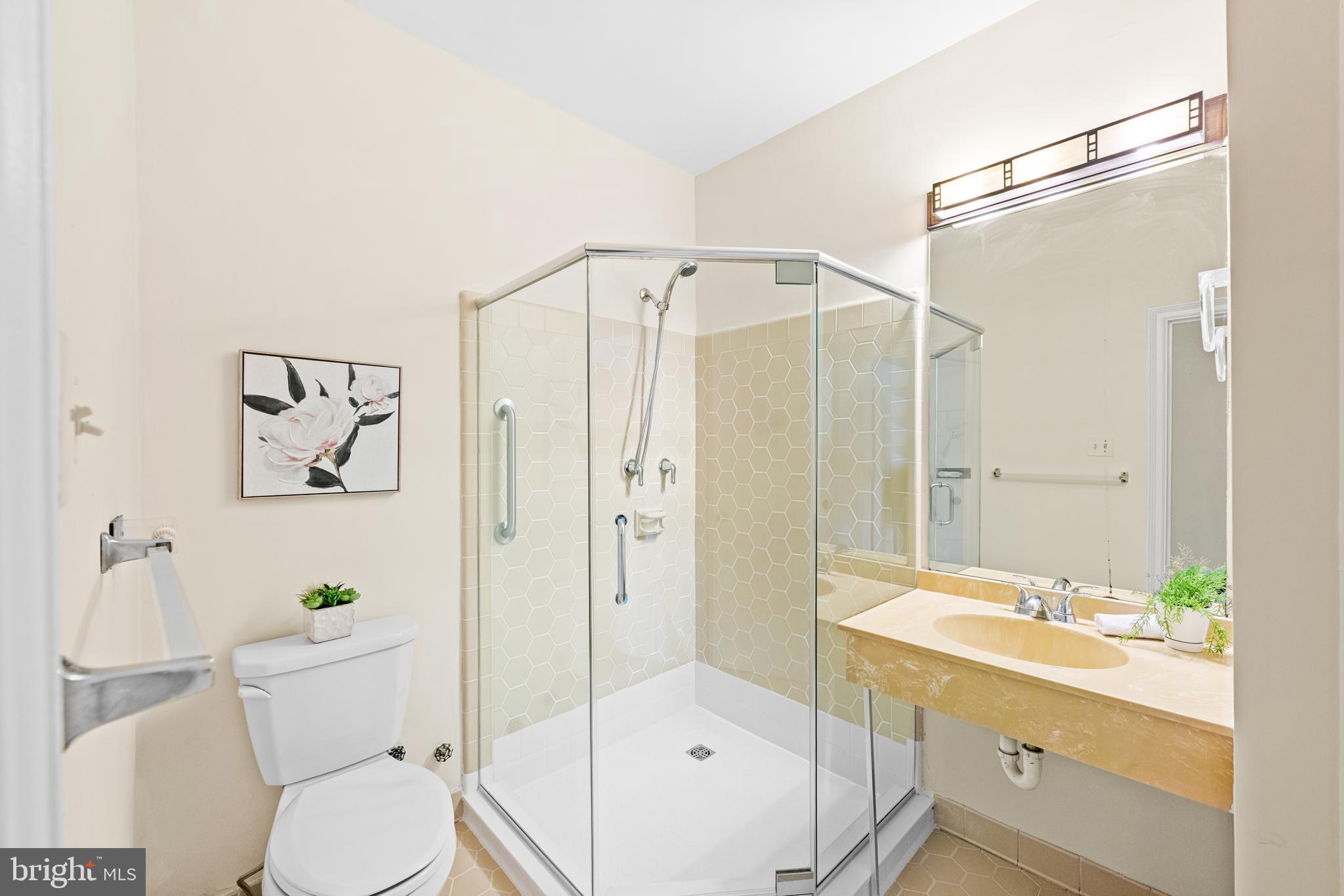 4701 Connecticut Avenue Northwest, Unit 501 Washington, DC 20008 - Photo 20 of 28 a bathroom with a shower toilet and a sink