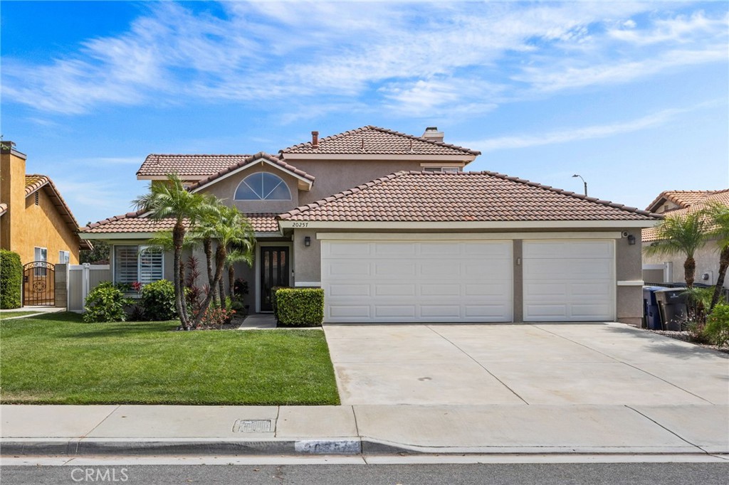 20257 Edmund Road Riverside, CA 92508 - Photo 2 of 53 a front view of a house with a yard and garage