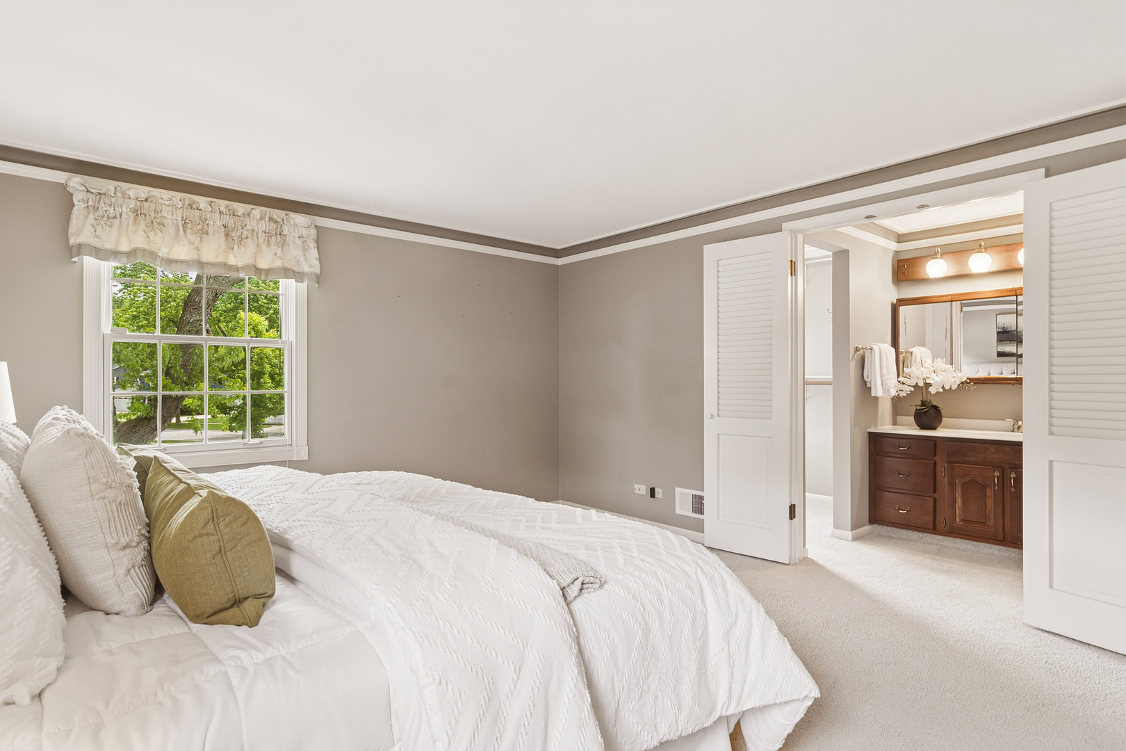 572 East Monterey Road Palatine, IL 60074 - Photo 21 of 27 a spacious bedroom with a bed and a dresser next to a window