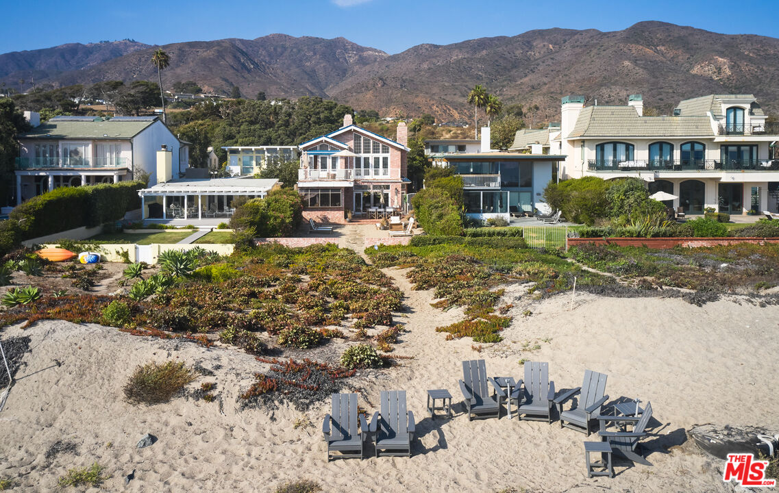 a view of house with a garden and a lake view