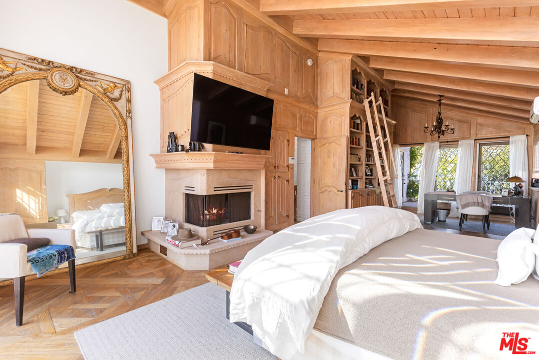 30870 Broad Beach Road Malibu, CA 90265 - Photo 12 of 28 a bedroom with a bed a fireplace and a fireplace