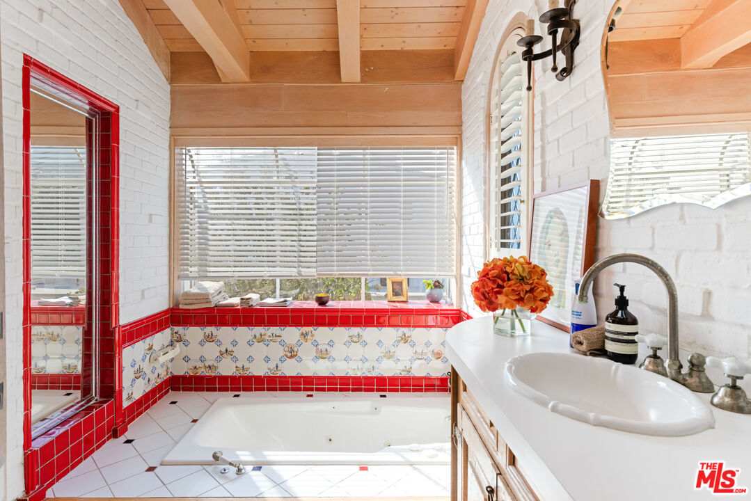 30870 Broad Beach Road Malibu, CA 90265 - Photo 15 of 28 a bathroom with a granite countertop sink and bathtub
