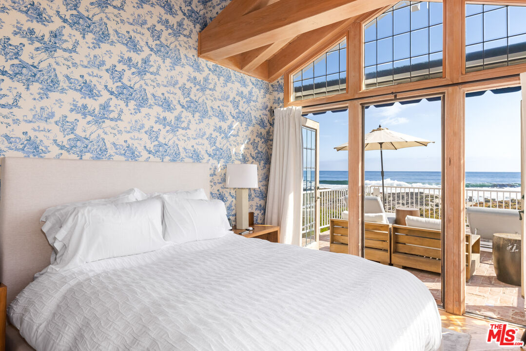 30870 Broad Beach Road Malibu, CA 90265 - Photo 16 of 28 a bedroom with a large bed and a large window