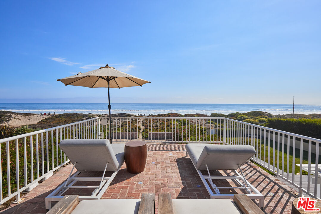 30870 Broad Beach Road Malibu, CA 90265 - Photo 17 of 28 a view of a balcony with wooden floor and outdoor seating