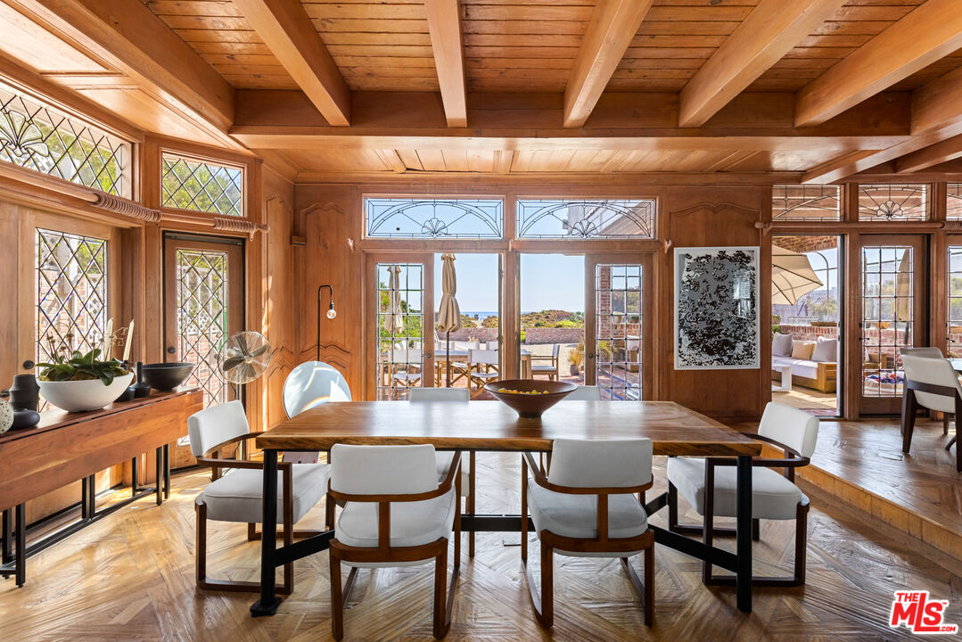 30870 Broad Beach Road Malibu, CA 90265 - Photo 8 of 28 a dining room with furniture large windows and a chandelier