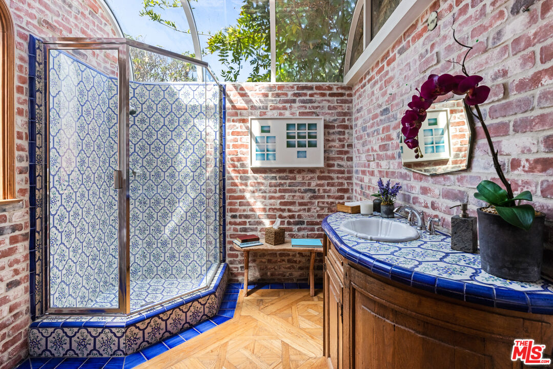 30870 Broad Beach Road Malibu, CA 90265 - Photo 10 of 28 a balcony with table and chairs and potted plants