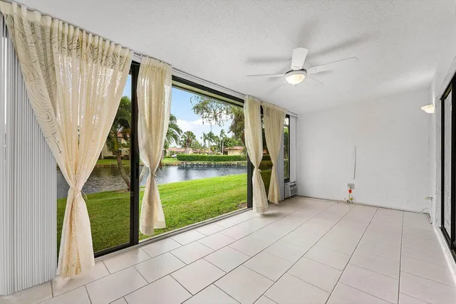 a view of swimming pool with a yard and trees in the background