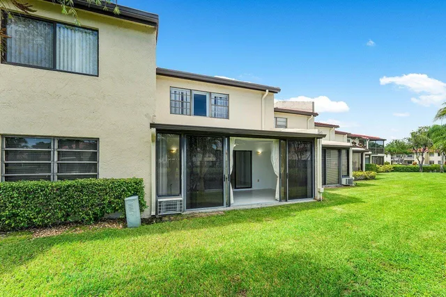 an aerial view of residential houses with outdoor space and swimming pool