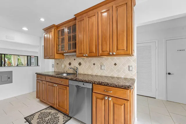 a kitchen with stainless steel appliances granite countertop a sink stove and cabinets