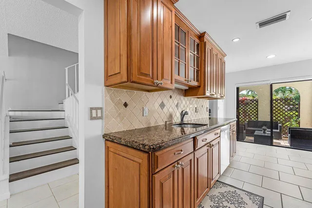 a kitchen with stainless steel appliances granite countertop a sink stove and cabinets