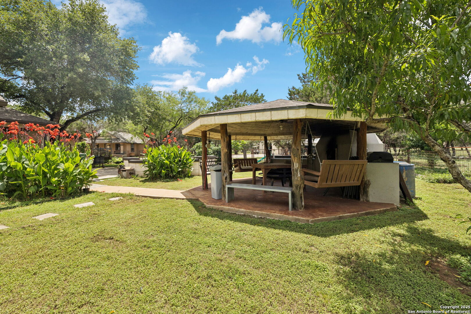 450 Georg Oaks Bulverde, TX 78163 - Photo 12 of 41 a view of a patio with table and chairs with wooden floor and fence
