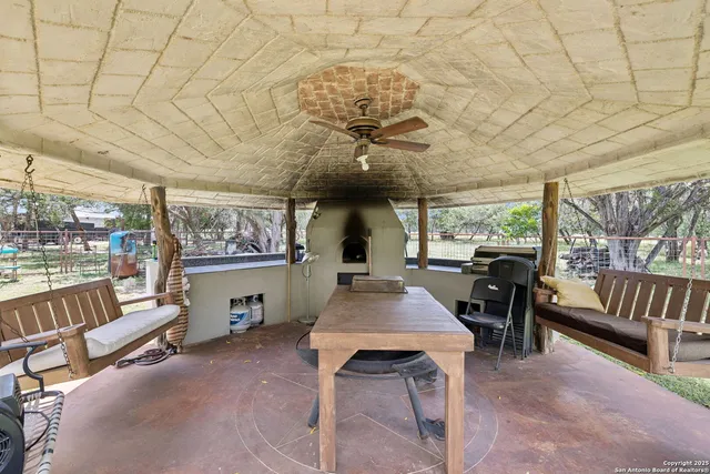 a dining room with furniture and a floor to ceiling window