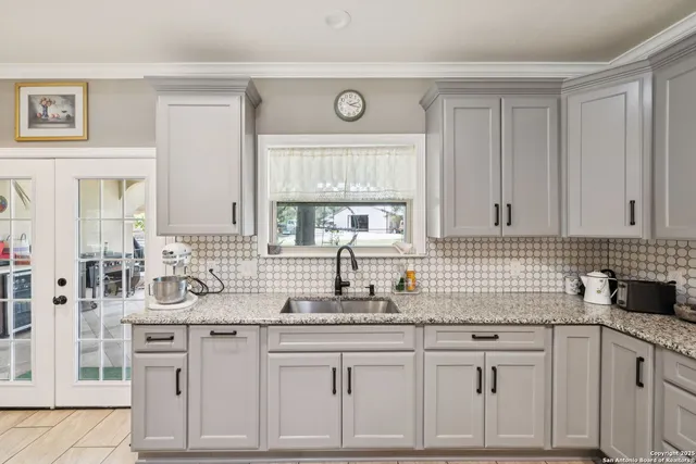 a kitchen with white cabinets and white appliances