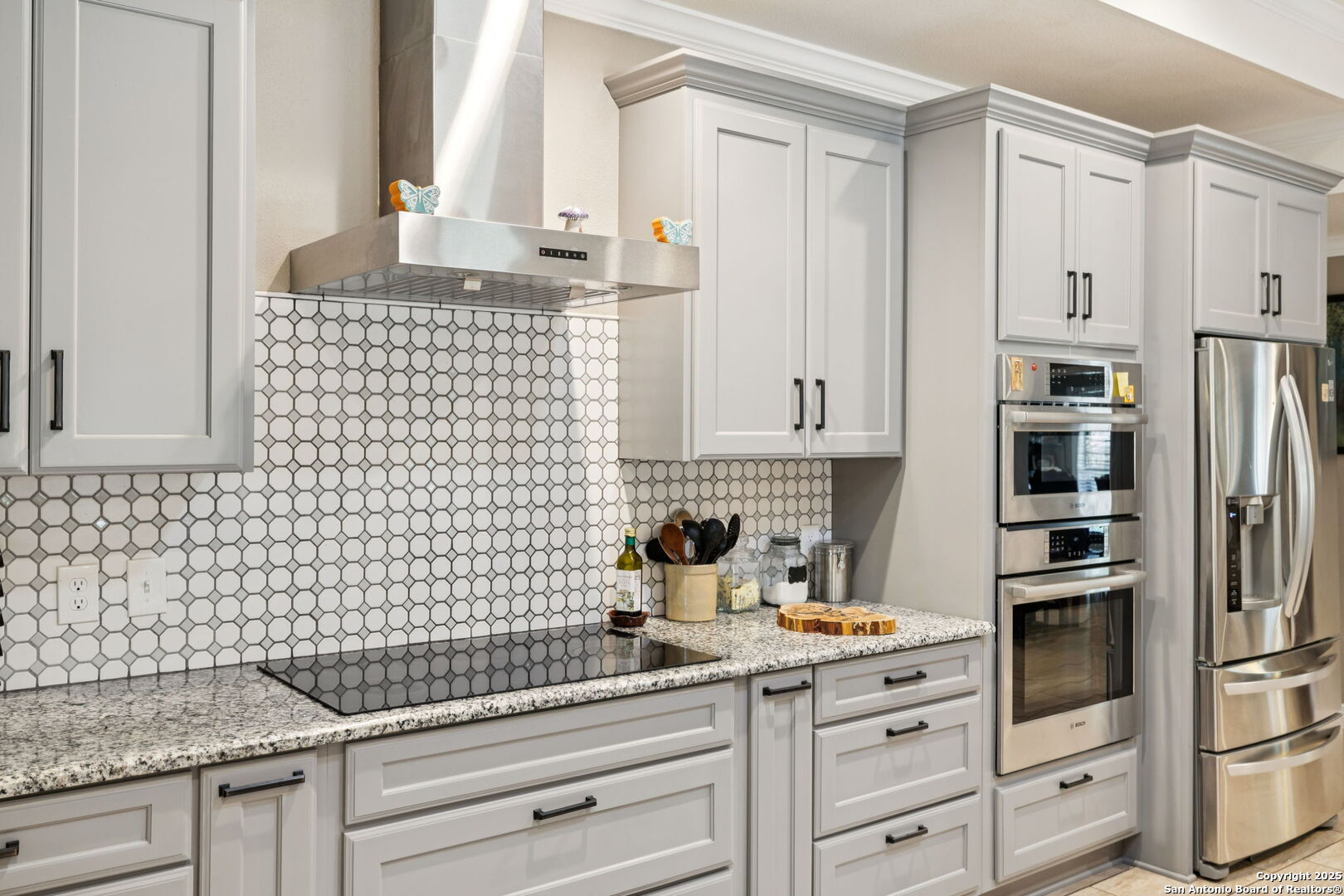 450 Georg Oaks Bulverde, TX 78163 - Photo 17 of 41 a kitchen with granite countertop white cabinets and stainless steel appliances
