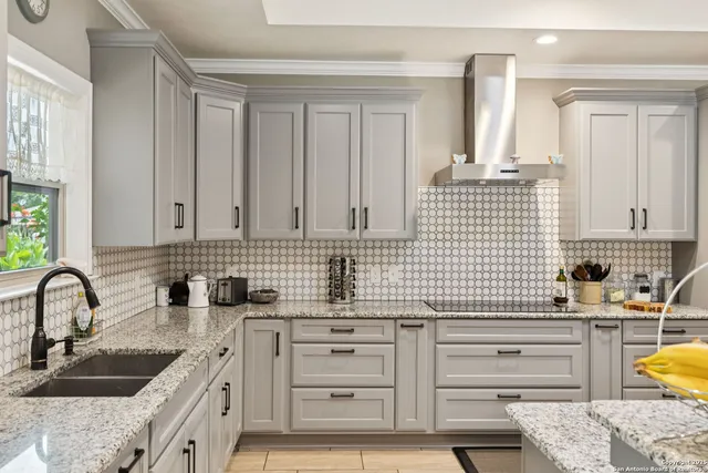 a kitchen with cabinets appliances and a sink