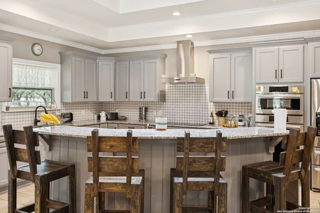 a kitchen with stainless steel appliances granite countertop a stove top oven a sink dishwasher and cabinets