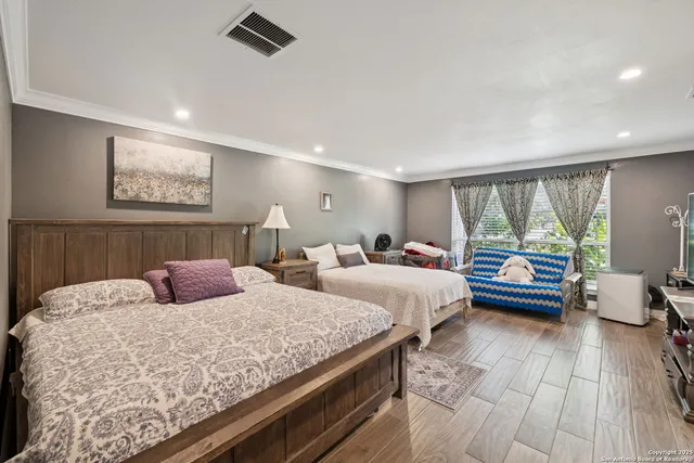 a bedroom with double bed and a large window