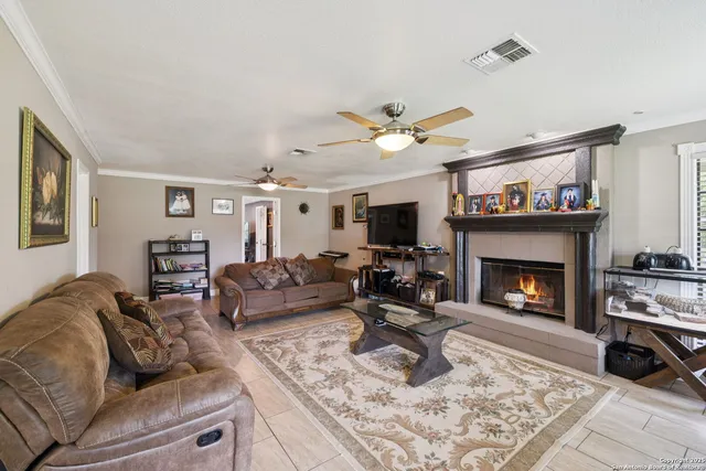 a living room with furniture a fireplace and a flat screen tv