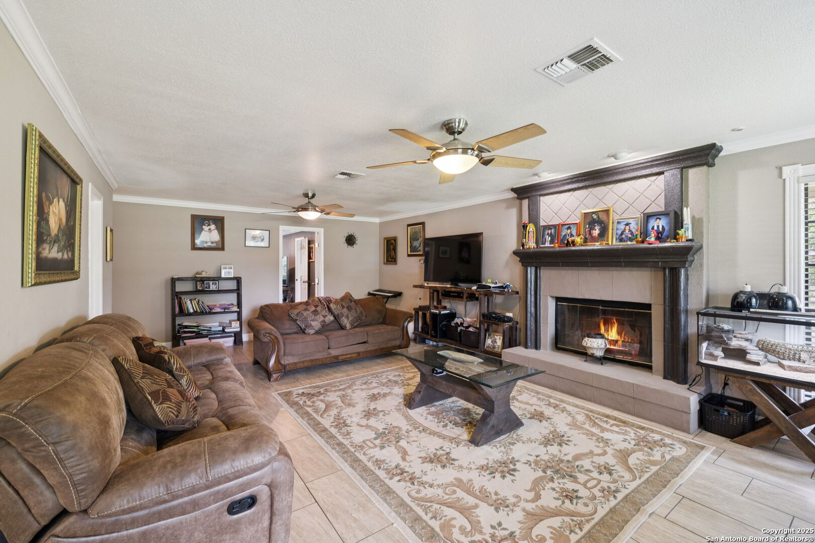 450 Georg Oaks Bulverde, TX 78163 - Photo 25 of 41 a living room with furniture a fireplace and a flat screen tv