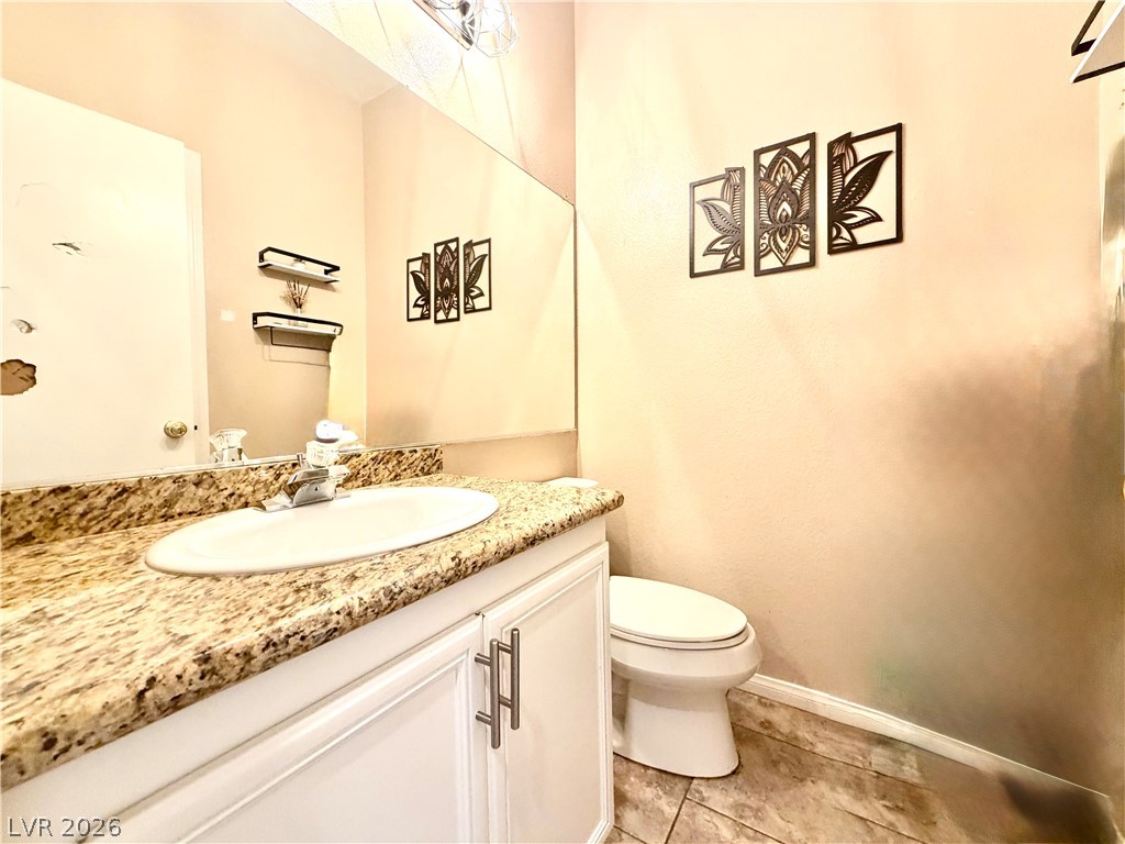 3936 Gold Point Street Las Vegas, NV 89129 - Photo 7 of 23 Granite counters and ample storage make this compact bathroom a practical space.