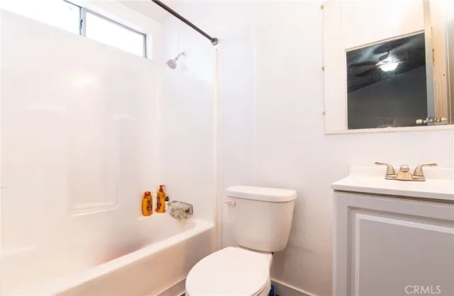 a bathroom with a toilet a sink and bathtub