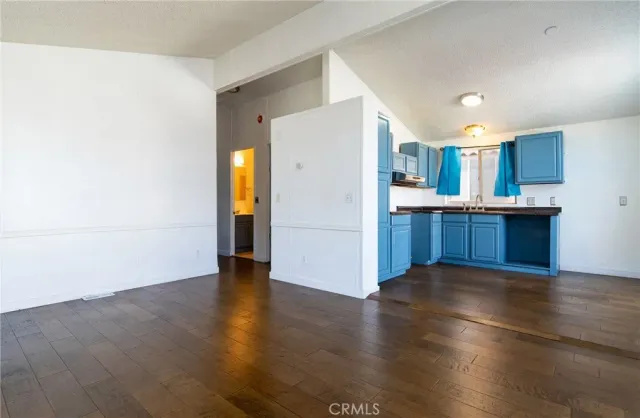 a view of a kitchen with a sink and cabinets