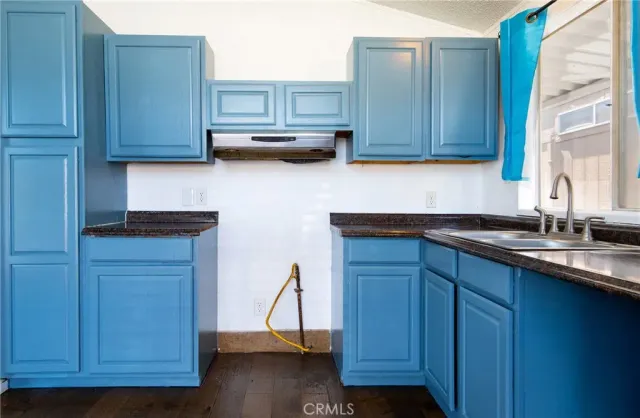 a kitchen with stainless steel appliances granite countertop wooden cabinets a sink and dishwasher