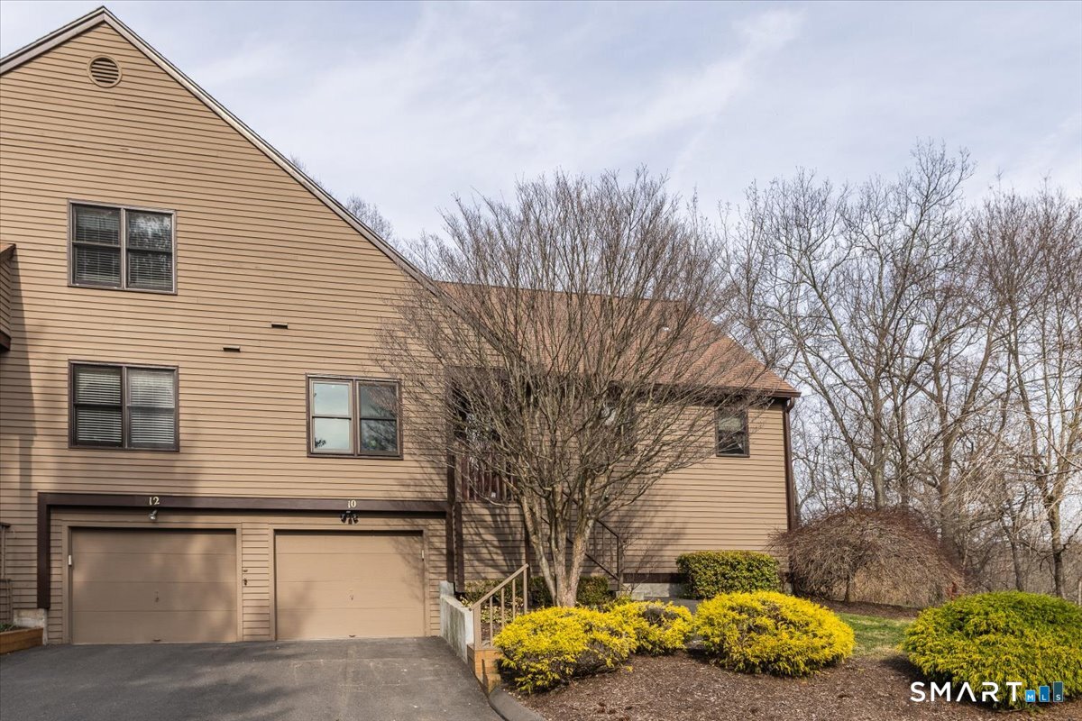 10 Juniper Circle, Unit 10 Monroe, CT 06468 - Photo 2 of 52 a front view of a house with a yard and garage