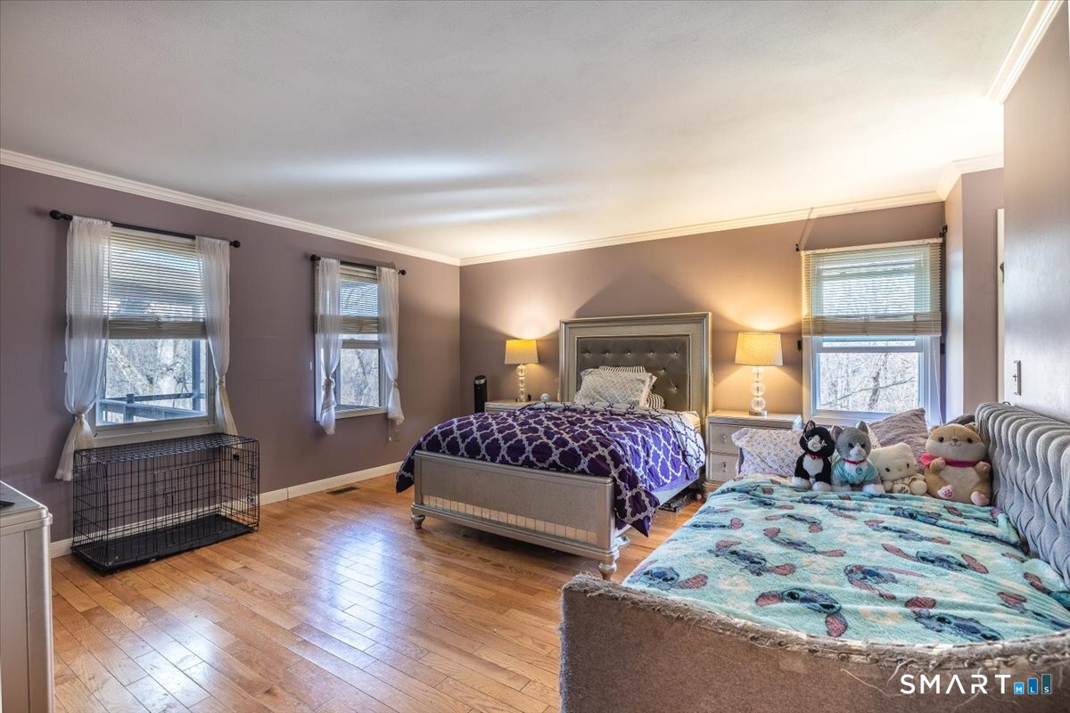 10 Juniper Circle, Unit 10 Monroe, CT 06468 - Photo 29 of 52 a spacious bedroom with a bed and wooden floor