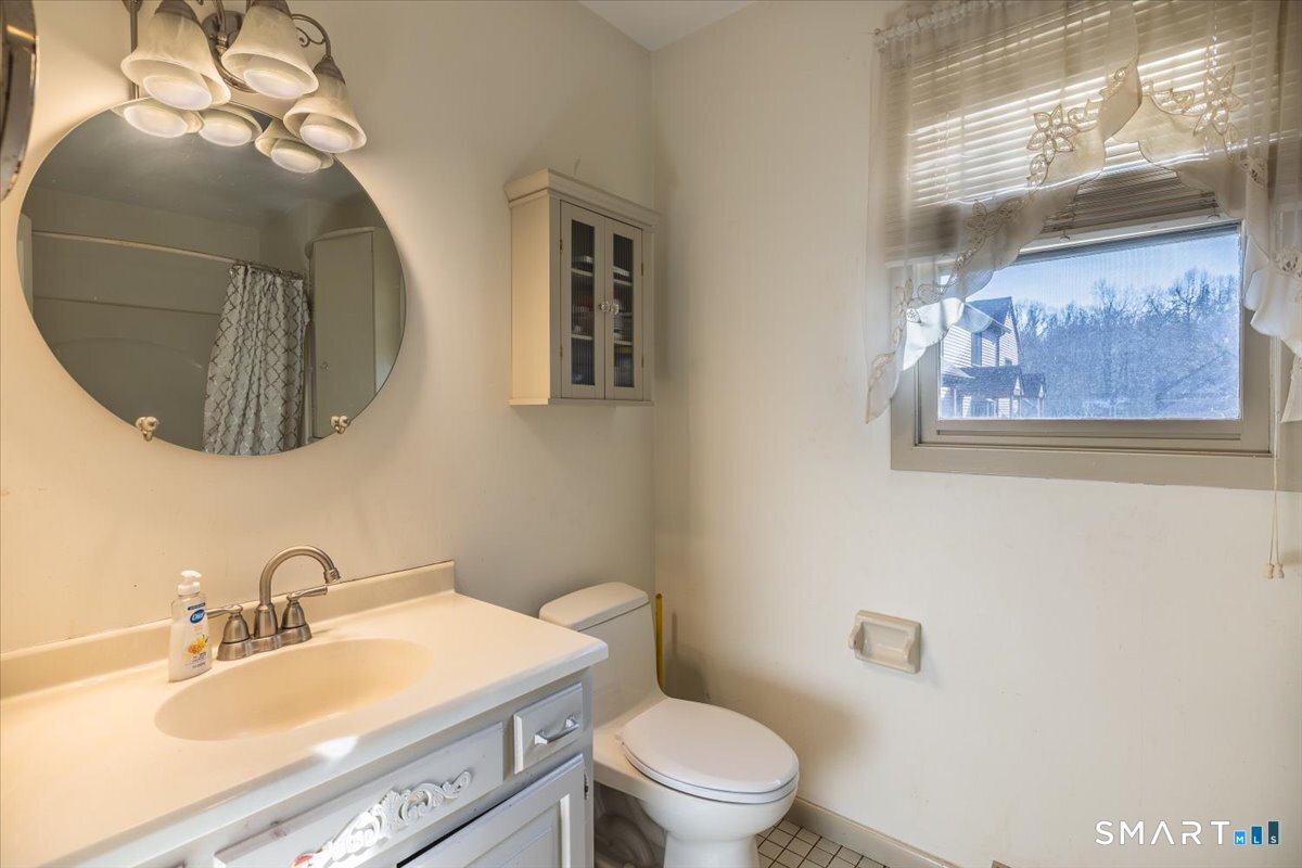 10 Juniper Circle, Unit 10 Monroe, CT 06468 - Photo 35 of 52 a bathroom with a toilet a sink and mirror