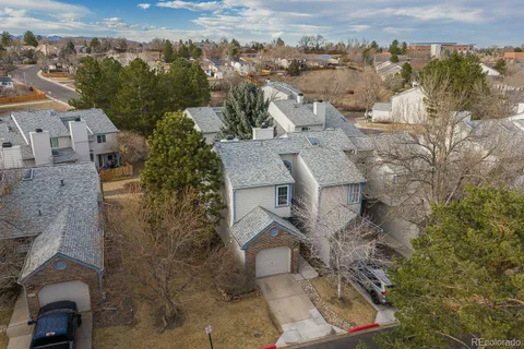 an aerial view of a house with a yard