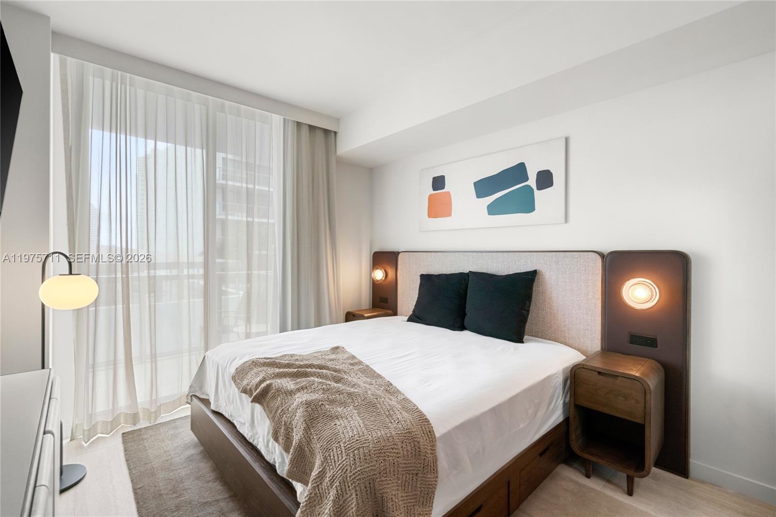 1611 Southwest 2nd Avenue, Unit 504 Miami, FL 33129 - Photo 2 of 17 a bedroom with a bed and a window