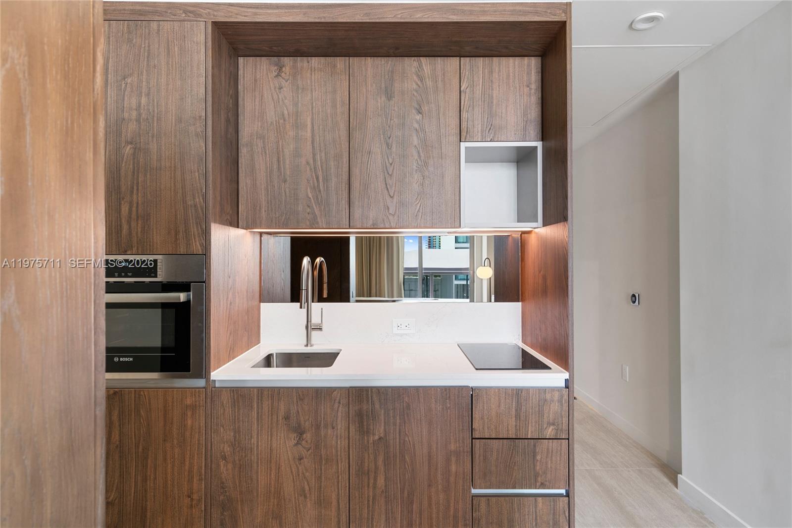 1611 Southwest 2nd Avenue, Unit 504 Miami, FL 33129 - Photo 7 of 17 a kitchen with a refrigerator and table