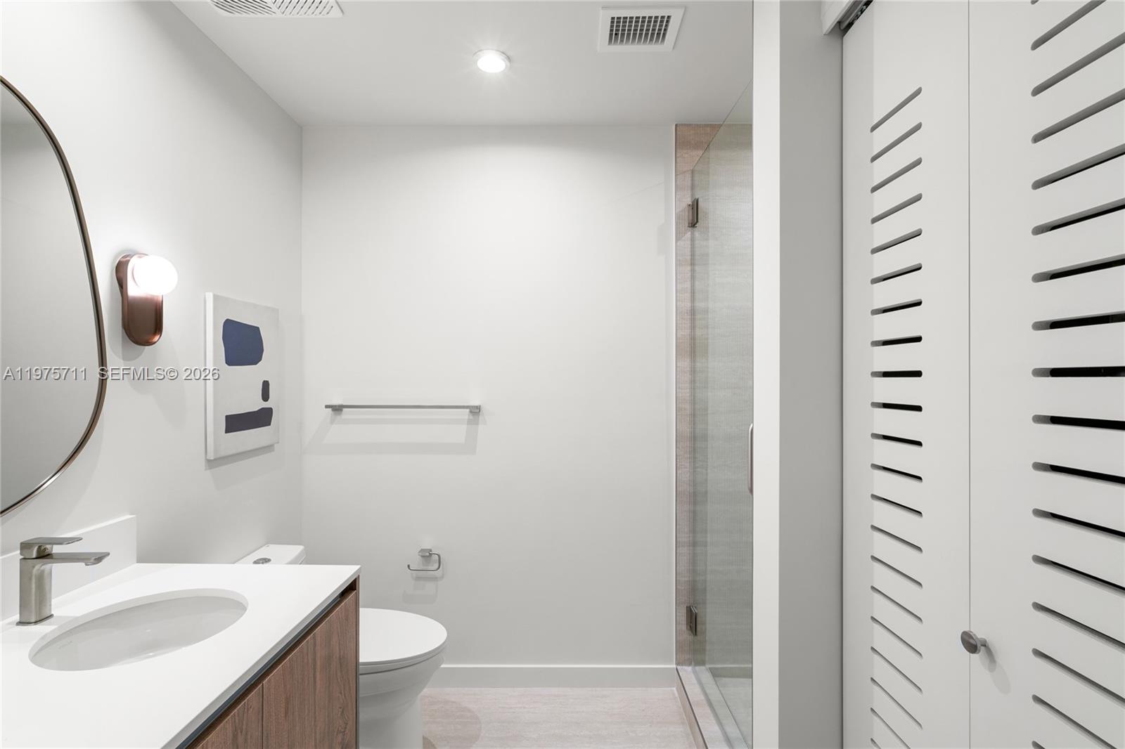 1611 Southwest 2nd Avenue, Unit 504 Miami, FL 33129 - Photo 8 of 17 a bathroom with a sink a toilet and shower