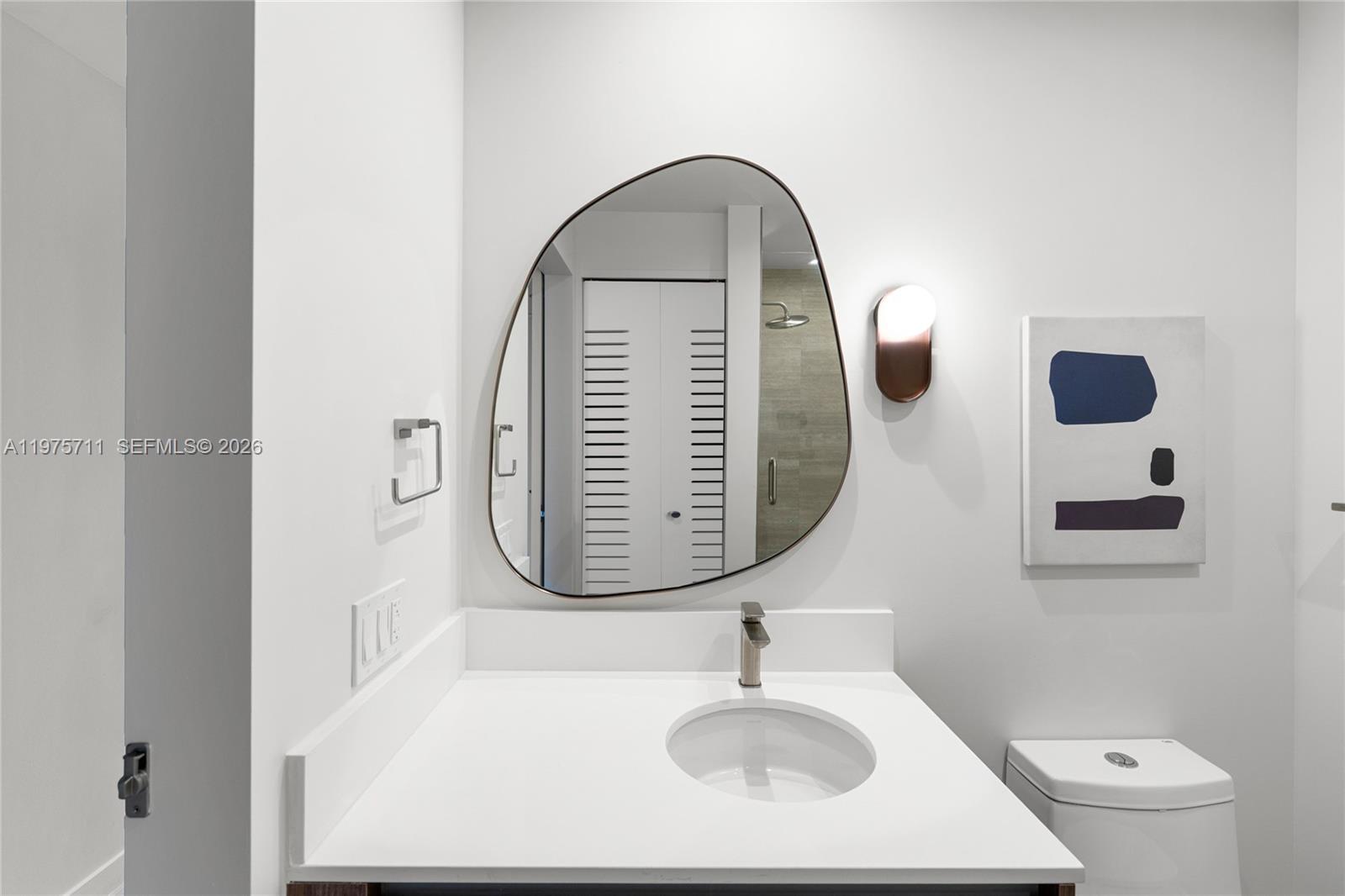 1611 Southwest 2nd Avenue, Unit 504 Miami, FL 33129 - Photo 9 of 17 a bathroom with a sink and a mirror