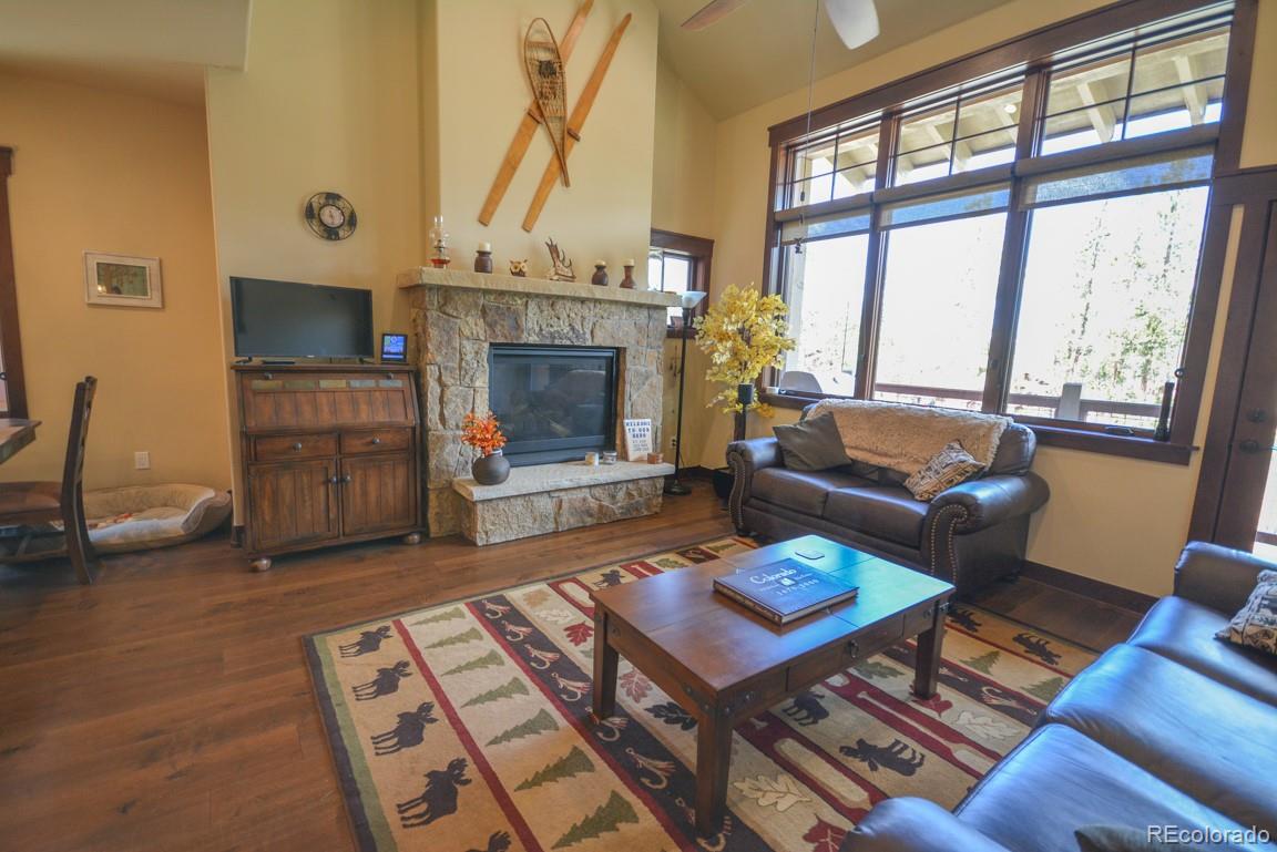 833 Independence Road Keystone, CO 80435 - Photo 19 of 38 a living room with furniture a fireplace and a floor to ceiling window