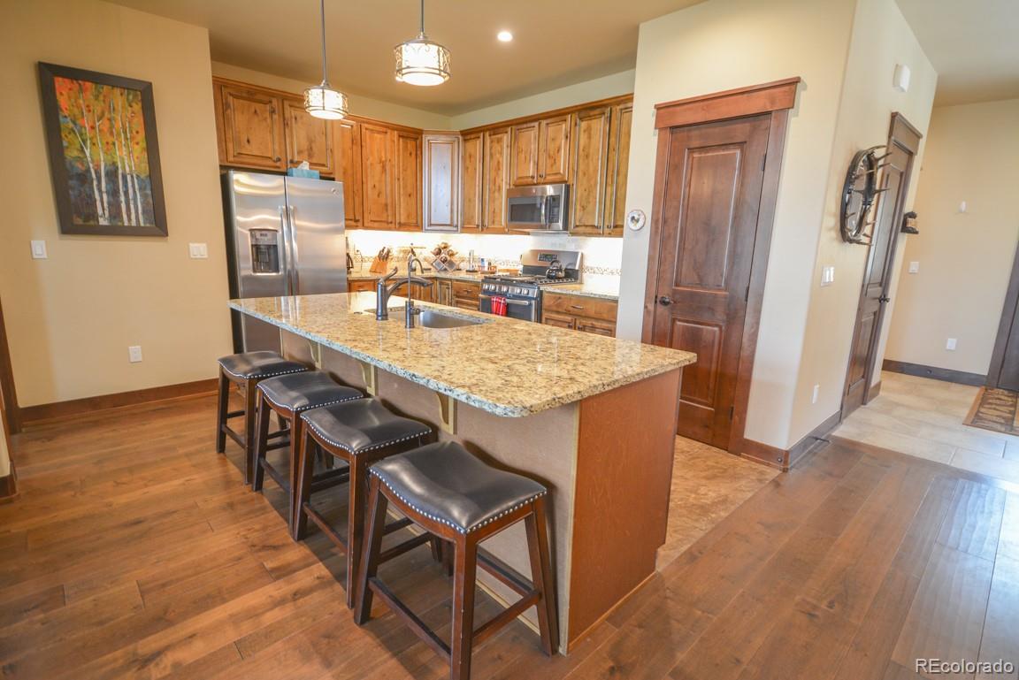 833 Independence Road Keystone, CO 80435 - Photo 2 of 38 a kitchen with stainless steel appliances granite countertop a refrigerator and a stove top oven