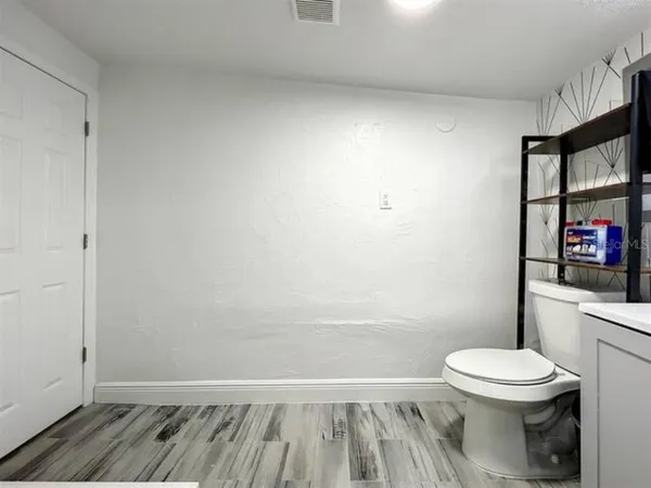 a kitchen with stainless steel appliances kitchen island granite countertop a refrigerator and a stove top oven